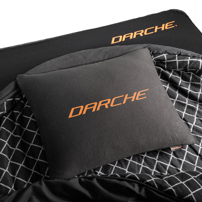 DARCHE Supreme Snoozer memory foam camping pillow next to its carry bag, compressed for packing inside a swag or overnight bag